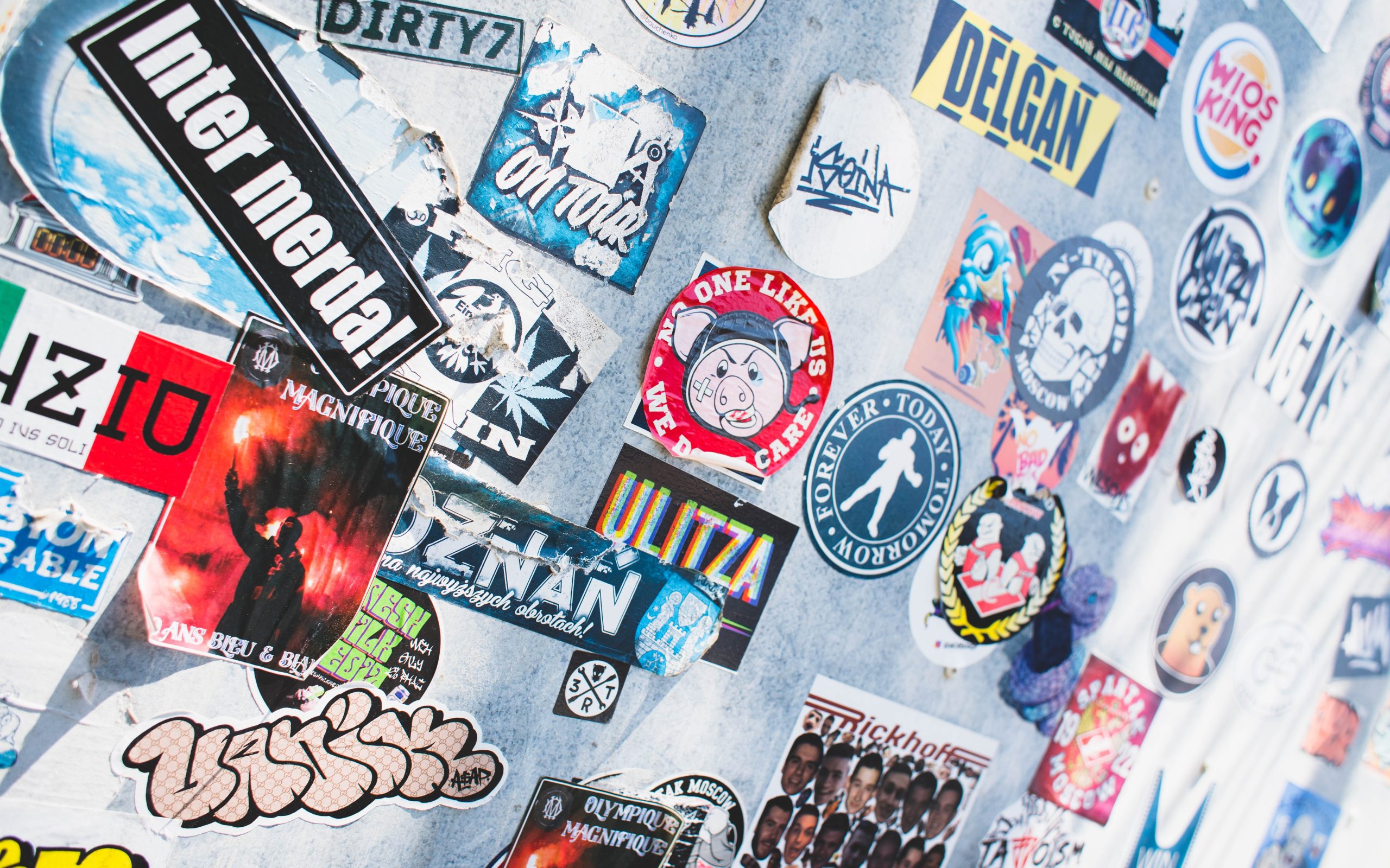 a wall covered in stickers.