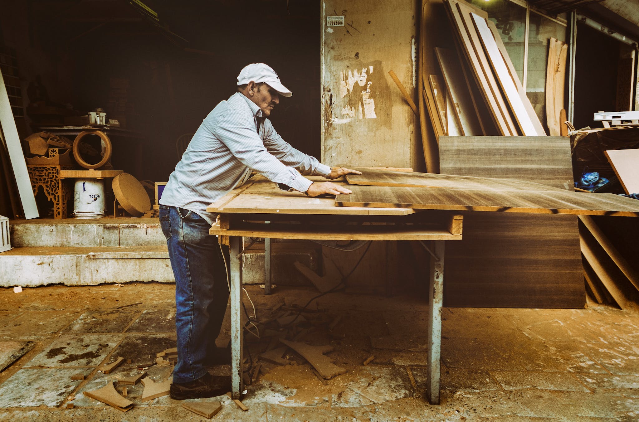 Man Using Table Saw on wood furniture.