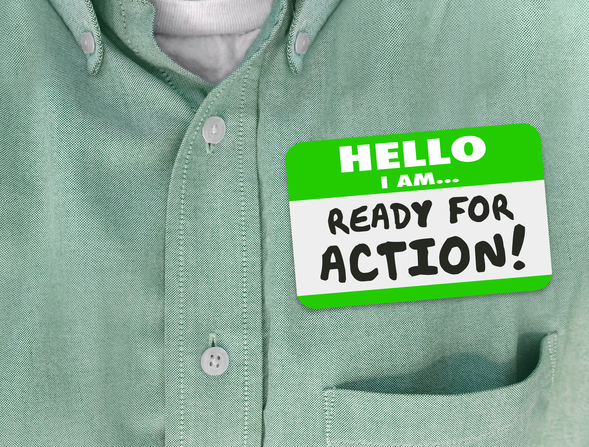 green shirt with a nametag sticker that says "hello I am... ready for action!".